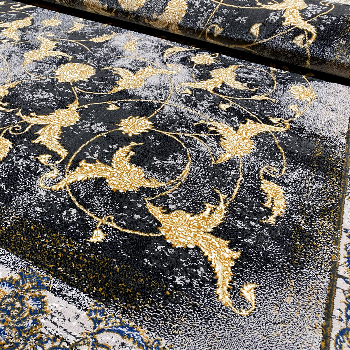 Alfombra de 160x230 cm con fondo oscuro y ornamentos dorados, de aspecto envejecido