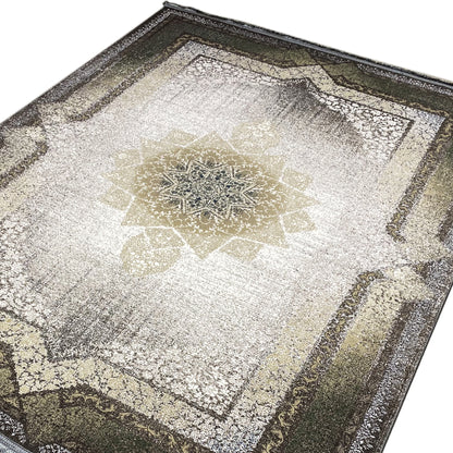 Grün-grauer Orientteppich mit Used-Look und Fransen.