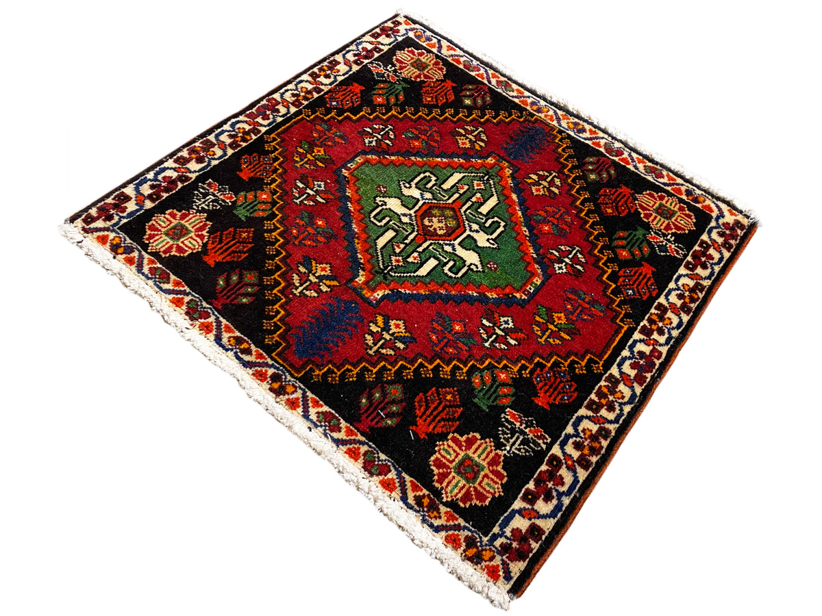 Alfombra Poshti cuadrada, diagonal: alfombra tejida negra con diseño central verde y rojo