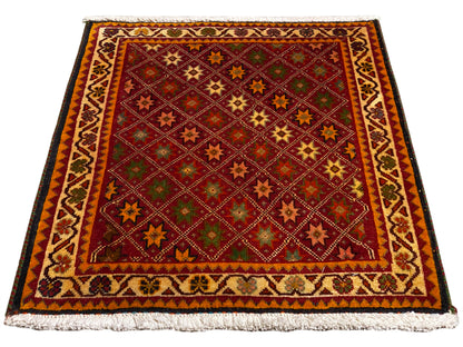 Alfombra Poshti, rectangular, multicolor, con cenefa decorativa y flecos en los bordes.