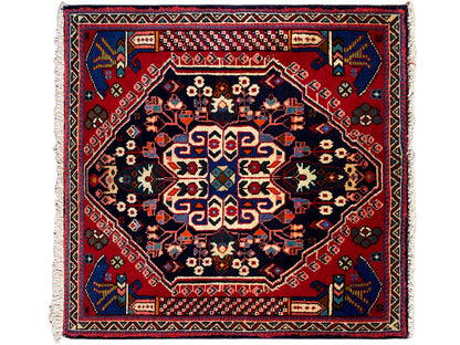 Alfombra Poshti de 66x63 cm con borde rojo, azul oscuro y patrón geométrico