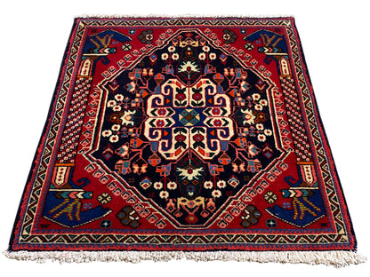 Alfombra Poshti de 66x63 cm, azul oscuro/rojo, con diseño de medallón y flecos en el borde