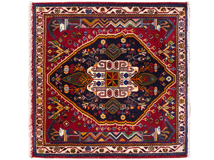 Alfombra Poshti (67×67 cm) con composición de medallones de varias partes, en azul oscuro y rojo