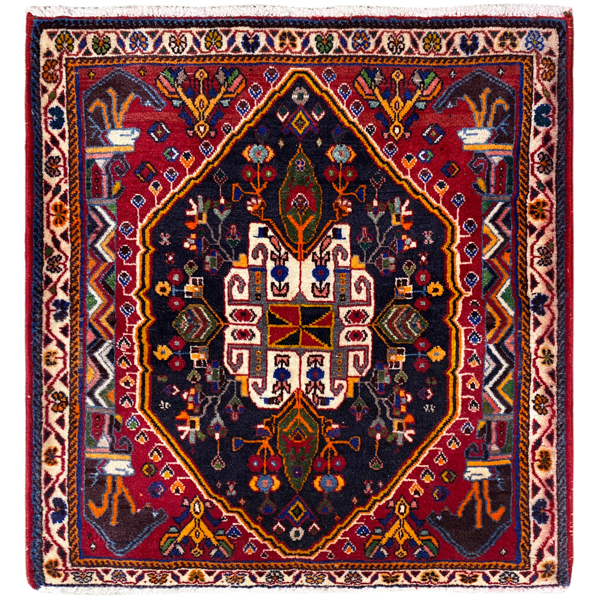 Alfombra cuadrada con fondo azul oscuro, marco rojo y diseño ornamental, 70x67 cm