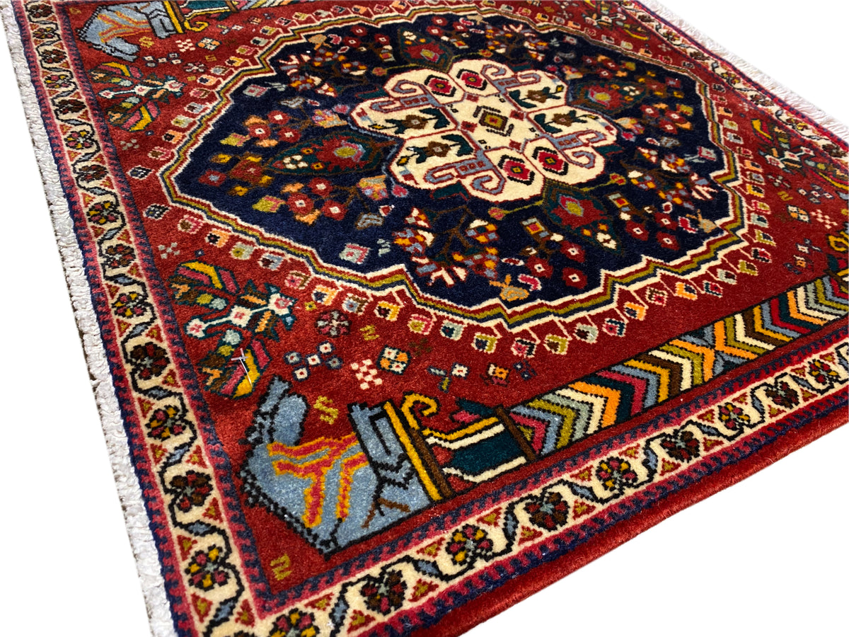 Alfombra Poshti de 65x61 cm, vista detallada: campo rojo, ornamento azul-negro, bordes en contraste