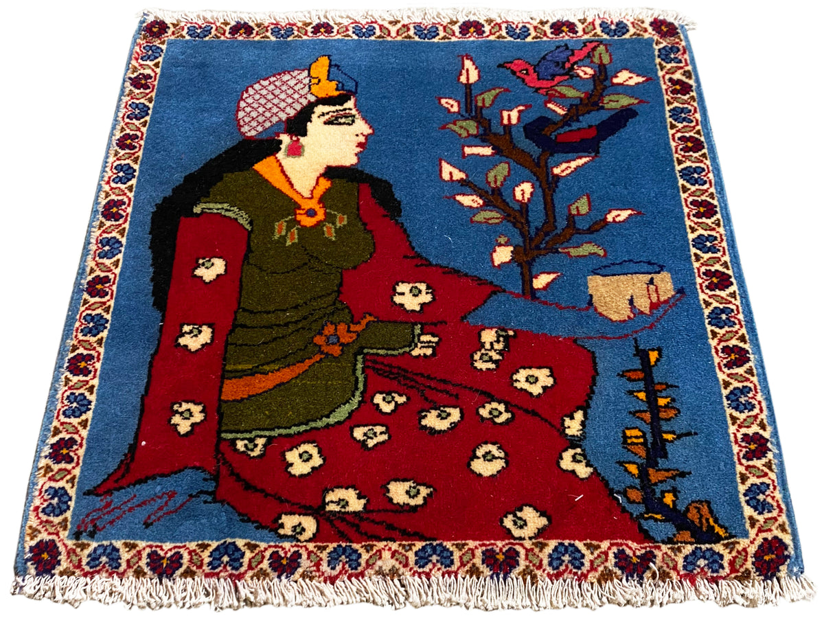 Cojín alfombra Poshti de 65x63 cm con motivo de cuento de hadas, superficie azul, parte central roja y flecos