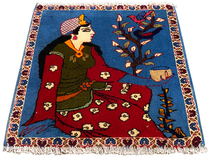 Cojín alfombra Poshti de 65x63 cm con motivo de cuento de hadas, superficie azul, parte central roja y flecos